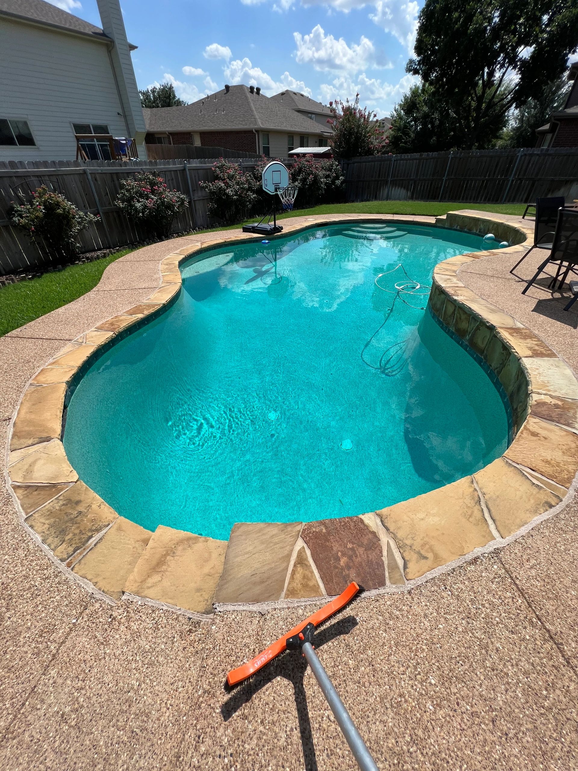 Curved pool with stone decking
