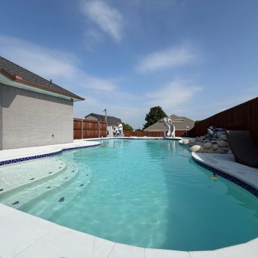 Kidney shaped pool sunny day